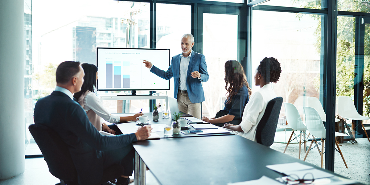 A man in a consulting firm presenting to a group about CRM strategy