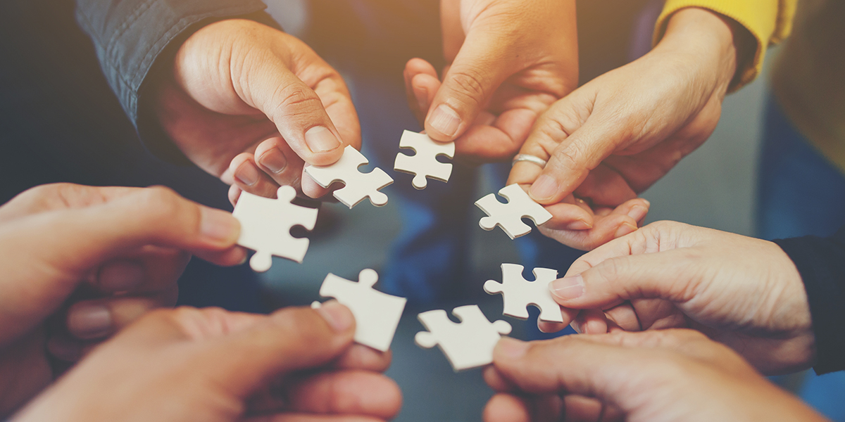 People holding puzzle pieces.